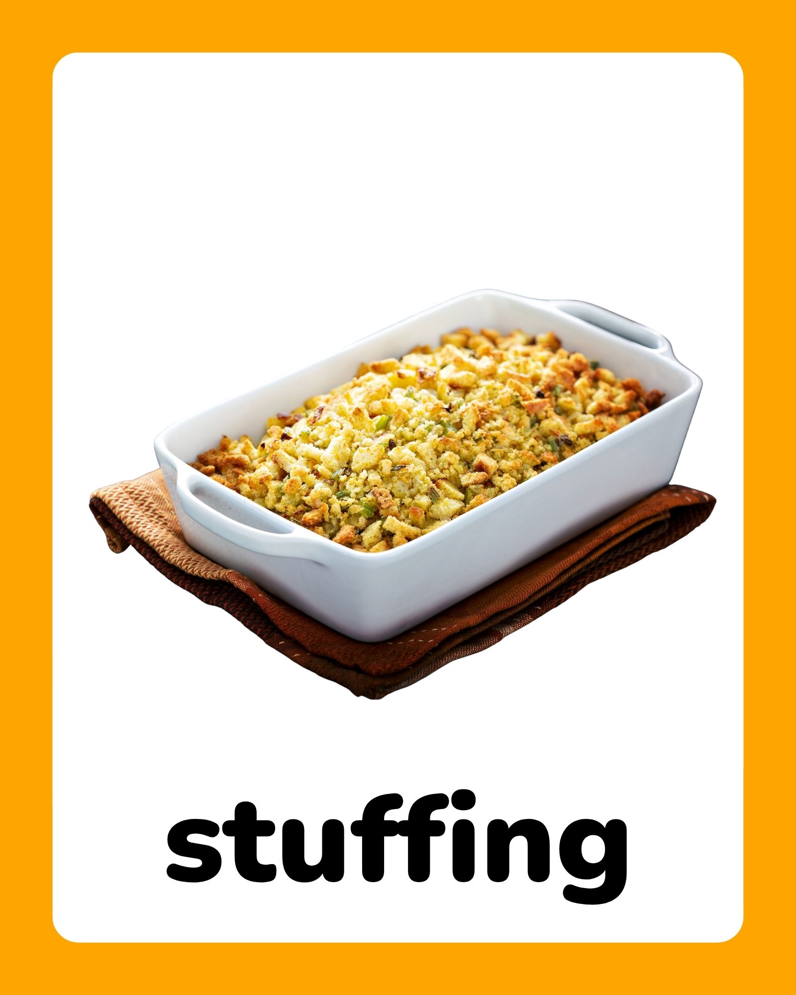 White ceramic baking dish filled with golden breadcrumb stuffing resting on folded brown napkins against a white and orange background.