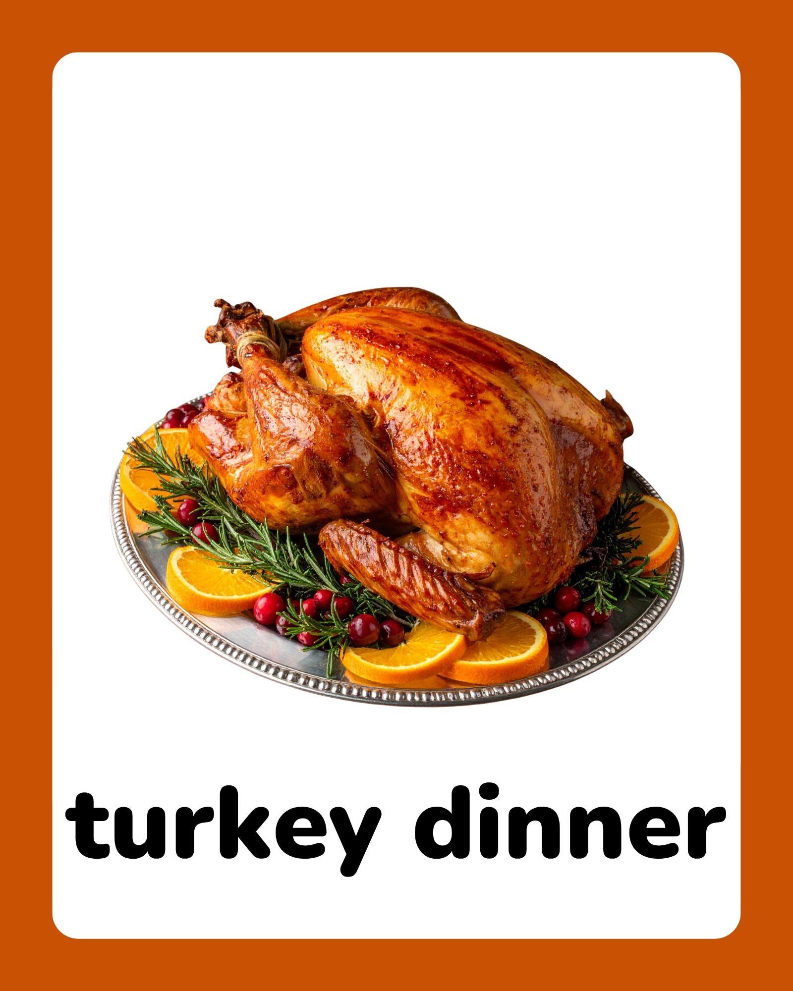 Roasted whole turkey on a silver platter garnished with orange slices, rosemary and cranberries against white background.